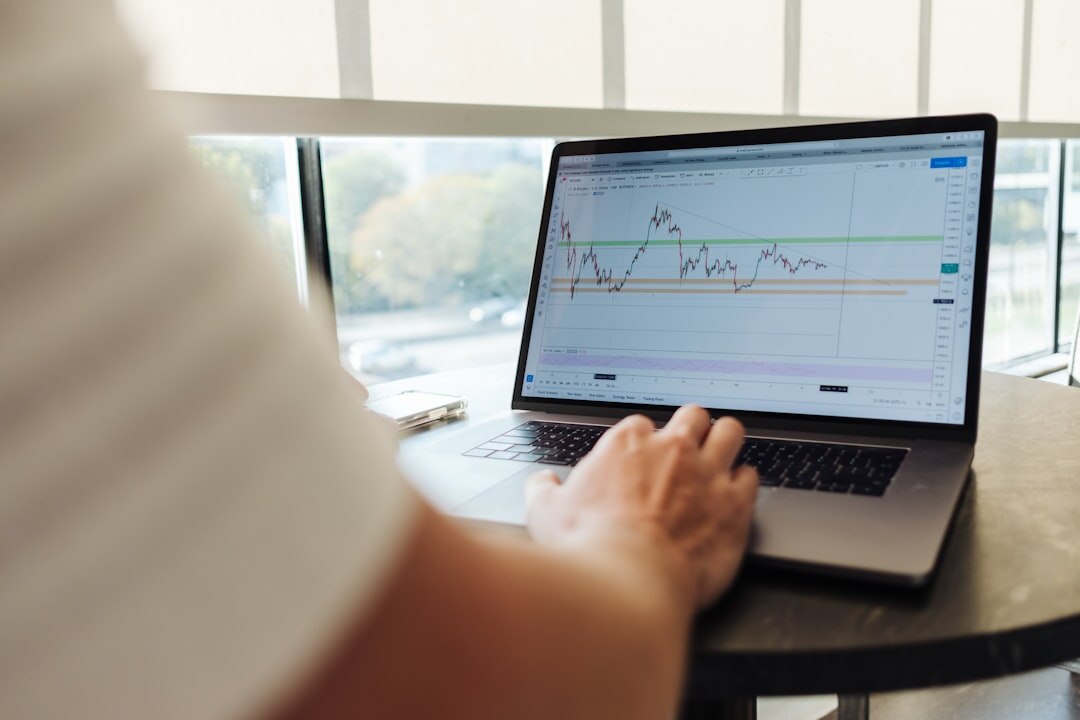 Person analyzing data trend graphs on a laptop screen
