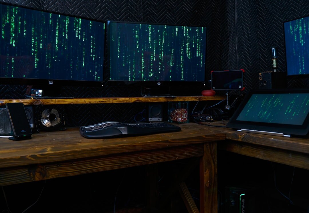 Journalist verifying information on multiple computer monitors